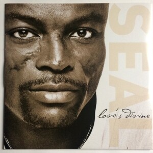 May include: A black and white photo of a man's face with the word "SEAL" in large letters on the right side of the image. The text "love's divine" is written in cursive at the bottom of the image.