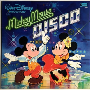 May include: A vintage vinyl record cover featuring Mickey Mouse and Minnie Mouse dressed in disco attire. The cover is blue with silver glitter and the text "Walt Disney Productions" and "Mickey Mouse Disco" in neon green.