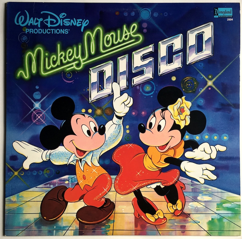 May include: A vintage vinyl record cover featuring Mickey Mouse and Minnie Mouse dressed in disco attire. The cover is blue with silver glitter and the text "Walt Disney Productions" and "Mickey Mouse Disco" in neon green.