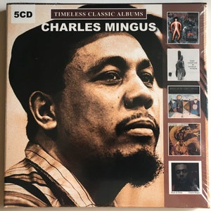 May include: A 5 CD box set of timeless classic albums by Charles Mingus. The box set features a close-up photo of Charles Mingus, and smaller images of album covers.