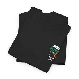 May include: Two black t-shirts are folded and stacked. The shirts have a small graphic on the lower right side that says "Split the G Club" in green, orange, and white. The shirts are made of a soft material.