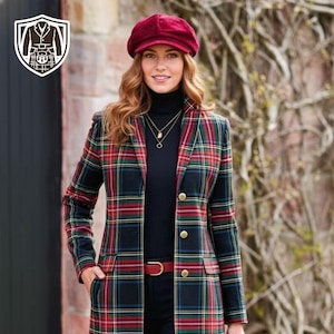 May include: A long plaid coat in red, green, and black, worn over a black turtleneck and pants. The coat has gold buttons and a red belt. A burgundy hat and black handbag complete the outfit. The coat features a classic tartan pattern.