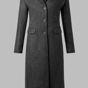 May include: A dark gray herringbone pattern coat with a notched collar, three buttons, and two front pockets. The long coat has a tailored fit and is suitable for cold weather. The coat is a classic design.