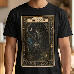 May include: Black t-shirt with a tarot card design, featuring the text "THE CODER." The card shows a robed figure using a laptop under a crescent moon. The design has gold and beige accents.