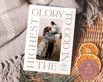 May include: A rectangular Christmas greeting card template featuring a central photograph of three people in a field. The card has a white border with the brown text GLORY TO GOD IN THE HIGHEST and the words merry christmas, THE AITKENS.
