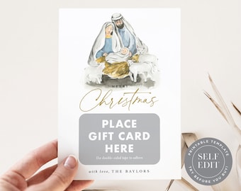 May include: A white Christmas gift card with a watercolor illustration of the Nativity scene. The card features the text "MERRY Christmas" in gold script, with a gray box for a gift card and the text "PLACE GIFT CARD HERE".