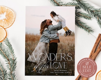 May include: A rectangular holiday card template featuring a photograph of a family in a field. The text reads WONDERS OF HIS LOVE, merry christmas, THE WILLIAMS FAMILY. A circular badge in the corner says PRINTABLE TEMPLATE SELF EDIT.