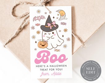 May include: A rectangular white gift tag featuring a cartoon ghost wearing a witch hat, a pumpkin, a bat, and a crescent moon. The text reads "Boo", "HERE'S A HALLOWEEN TREAT FOR YOU!", and "from, Addie" in pink and black lettering with floral accents.