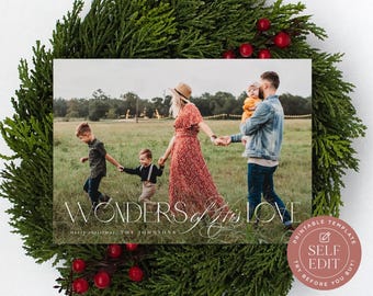 May include: A rectangular holiday card template featuring a family walking in a grassy field, framed by a green wreath. The text reads WONDERS of HIS LOVE and merry christmas, THE JOHNSONS. A circular badge in the corner says PRINTABLE TEMPLATE SELF EDIT.