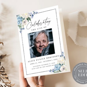 May include: A printable memorial card template with a floral design in shades of blue and white. The card features a photo placeholder, the text "Celebrating the Life of", and space for the deceased's name, dates, and service information. The text "Try Before You Buy! Self Edit" is also included.