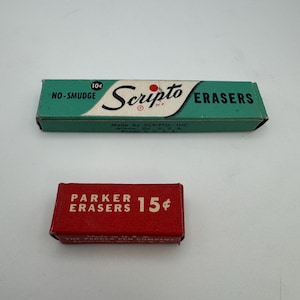 May include: Two vintage eraser boxes. The top box is green with "Scripto Erasers" printed on it. The bottom box is red with "Parker Erasers" printed on it. Both boxes have text indicating the price.