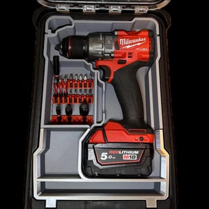 May include: A red and black Milwaukee FUEL drill with a 5.0 Ah REDLITHIUM M18 battery is stored in a gray plastic case with a compartment for drill bits.