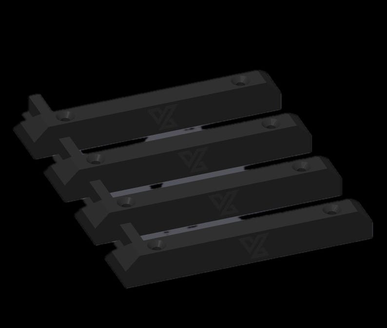 May include: A set of four black, rectangular mounting brackets arranged in a parallel formation. Each bracket features a distinct geometric logo embossed on the surface and two pre-drilled circular holes for installation purposes.