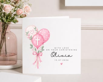 May include: A square white greeting card featuring a watercolor illustration of three pink balloons tied with a pink ribbon and green leaves. The center balloon has a white cross. Text reads: WITH LOVE ON YOUR CHRISTENING, Olivia, 15.07.2026.