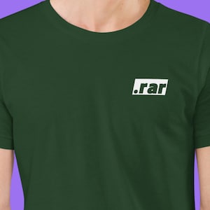 May include: Dark green t-shirt with a white rectangular graphic on the chest. The graphic contains the text ".rar" in a sans-serif font. The shirt has a crew neck and short sleeves.