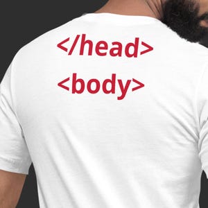 May include: White t-shirt with red text that reads "</head> <body >". The shirt is made of a soft material and has a crew neck. The design is simple and modern, perfect for casual wear.