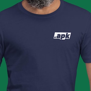 May include: Navy blue t-shirt featuring the white text ".apk" within a white rectangle. The shirt is made of a soft material and has a crew neck.