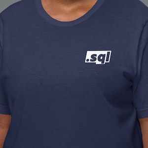 May include: Navy blue t-shirt featuring a white square graphic with the text ".sql". The shirt has a crew neck and is made of a soft fabric. The graphic is positioned centrally on the chest.