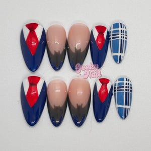 May include: A set of ten artificial nails. The nails feature a variety of designs, including a blue suit with a red tie, a nude base with a dark gradient, and a blue plaid pattern. The nails are almond-shaped.