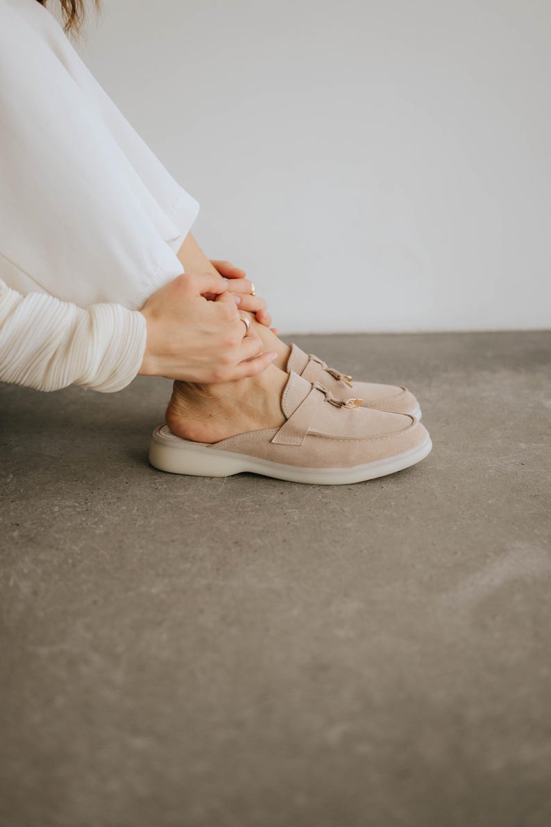 Handmade women’s suede slip-on loafers in light beige with decorative tassels