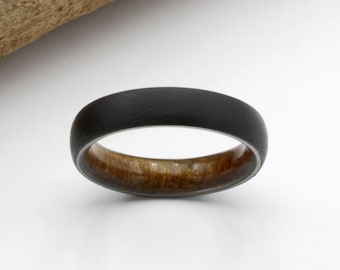 May include: A black and brown wood ring with a brushed finish.