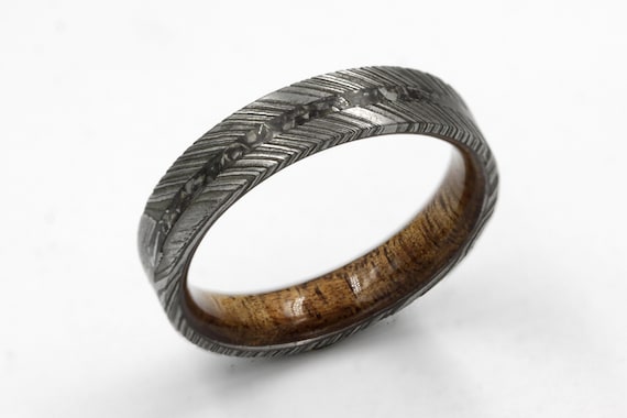 A ring made from actual Gibeon meteorite and Hawaiian Koa wood inlaid in Damascus steel — you're literally wearing outer space on your finger.