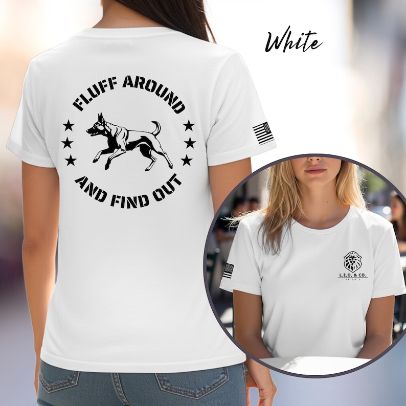 May include: White t-shirt with a black graphic of a dog and the text "FLUFF AROUND AND FIND OUT". The shirt also features a small American flag on the sleeve and the text "White" in cursive.