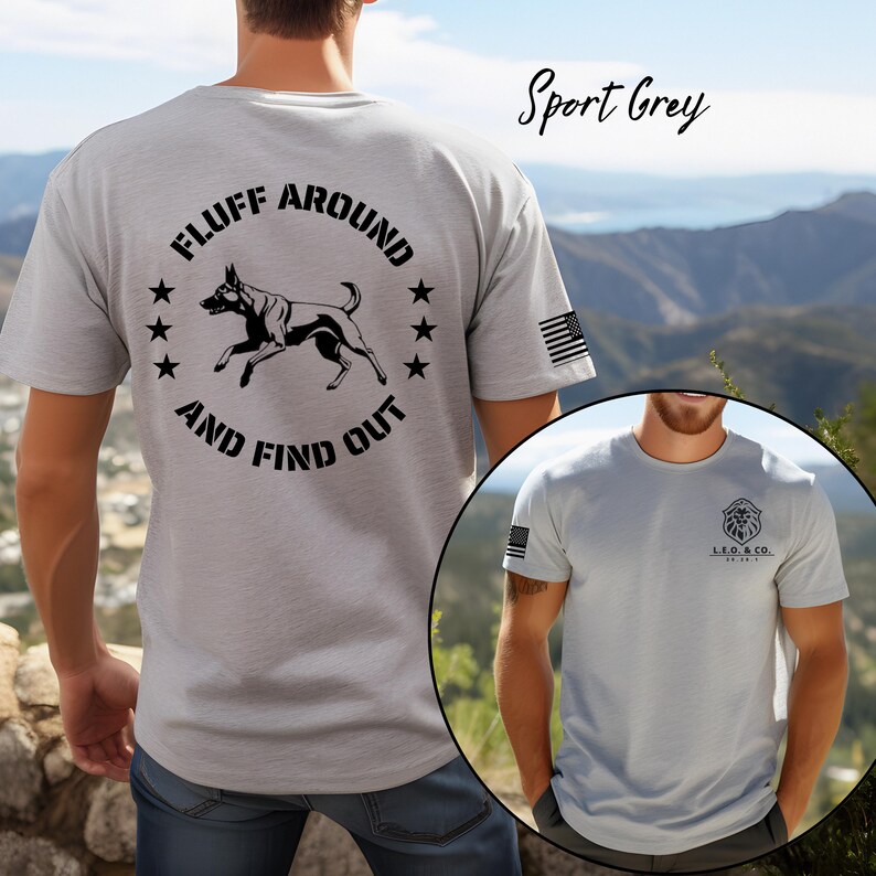 May include: Sport grey t-shirt with a graphic on the back that says "FLUFF AROUND AND FIND OUT" with a dog illustration and stars. The shirt also has an American flag on the sleeve and a logo on the front.