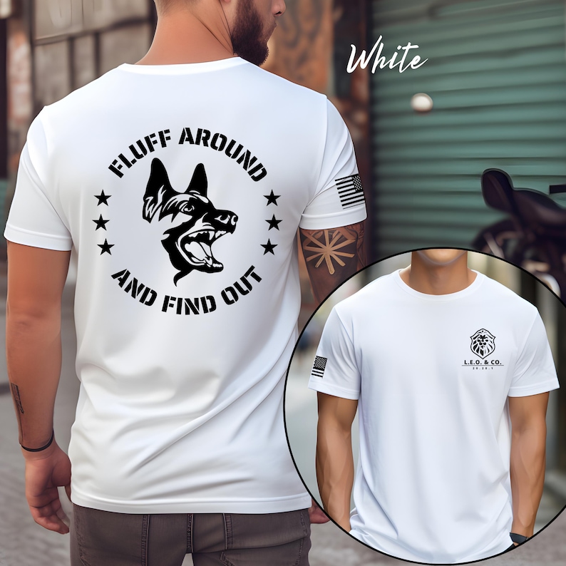 May include: White t-shirt with a black graphic of a dog's head and the text "FLUFF AROUND AND FIND OUT". The shirt also features a small American flag on the sleeve and a logo on the front.