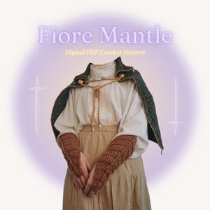 May include: A digital PDF crochet pattern for a Fiore Mantle. The image shows a green and gold cape, a white blouse, and brown crochet arm warmers. The text "Fiore Mantle" and "Digital PDF Crochet Pattern" are visible.