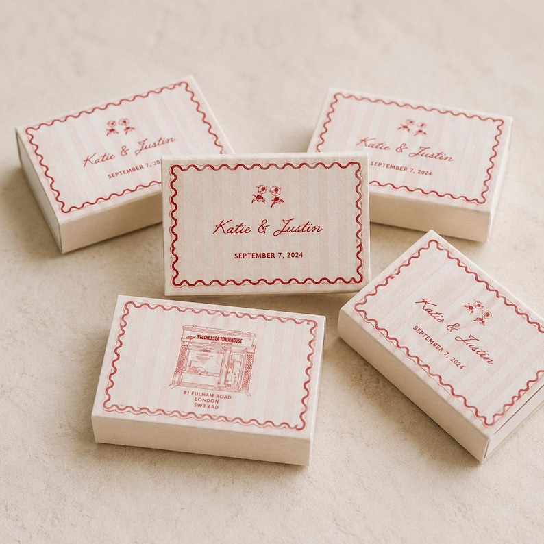 May include: Five rectangular matchboxes with a light pink striped pattern and a red scalloped border. Four boxes feature the text Katie & Justin and September 7, 2024. One box displays a line drawing of a storefront with the text 81 Fulham Road.