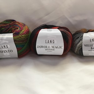 May include: Three skeins of Lang Yarns. The first is a multicolored Dipinto yarn, the second is Jawoll Magic Degrade, and the third is Mille Colori Baby. Each skein has a white label with the brand name and yarn type.