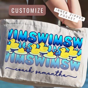 May include: A white canvas tote bag featuring a repeating blue text pattern that reads SWIM, accompanied by a graphic of yellow rubber ducks floating on water. The bag includes the custom text coach samantha in a dark blue script font.