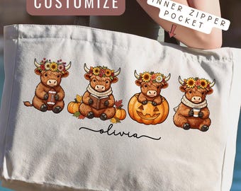 May include: A white canvas tote bag featuring a graphic of four cartoon highland cows wearing flower crowns, with one holding a football, one reading a book, one inside a pumpkin, and one holding a coffee cup. The name Olivia is printed below.