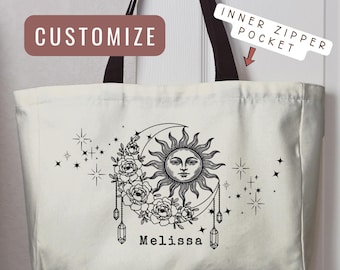 May include: A cream-colored canvas tote bag with black handles and a black graphic print featuring a sun, a crescent moon, flowers, stars, and hanging crystals. The name Melissa is printed below the design. Text labels read CUSTOMIZE and INNER ZIPPER POCKET.