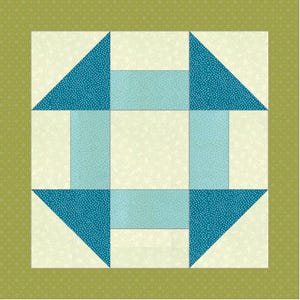 May include: A square quilt block featuring a central cream square surrounded by four light blue rectangular segments. Four dark teal triangles with white speckles are positioned at the corners, framed by a border of olive green fabric with white dots.