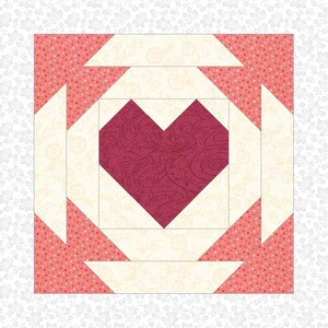 May include: A quilt block with a red heart in the center surrounded by white and pink squares with white polka dots.