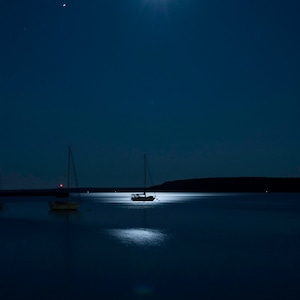Sailboat print. Night photography. Night photo. Moon photography. Moon photo. Sailboat bobbing in the harbor at night on Mackinac Island. Deep blue coloration with moonlight on the water. Gift for him. Gift for her. Wedding gift for the couple.