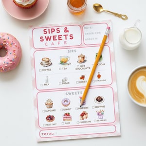 May include: A cafe menu titled "Sips & Sweets Cafe" with a pink and white checkered design. The menu features illustrations of coffee, tea, and sweets like cupcakes and donuts. A yellow pencil rests on the menu, with a donut and a cup of coffee nearby.