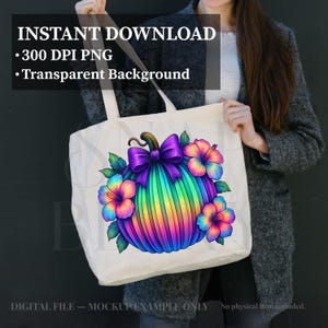 May include: A white tote bag featuring a vibrant, rainbow-colored pumpkin graphic with a purple bow and colorful hibiscus flowers. The text INSTANT DOWNLOAD, 300 DPI PNG, and Transparent Background is visible at the top of the image.