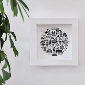 May include: Black and white illustration of iconic London landmarks, including Big Ben, the London Eye, and Buckingham Palace, arranged in a circle with the word "LONDON" in the centre. The illustration is framed in a white frame.
