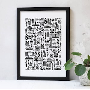 May include: Black and white illustration of London landmarks, including Big Ben, the London Eye, and the Tower Bridge. The illustration is framed in a black frame and is displayed on a white wall.