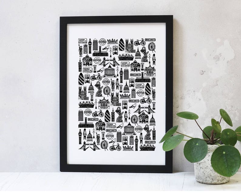 May include: Black and white illustration of London landmarks, including Big Ben, the London Eye, and the Tower Bridge. The illustration is framed in a black frame and is displayed on a white wall.