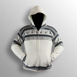May include: A white zip-up hoodie with a patterned design in shades of gray and black. The design includes geometric shapes and llama figures. The hoodie has a hood and two front pockets. The zipper is silver.
