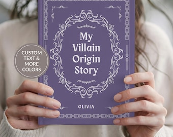 May include: A purple hardcover book with white decorative filigree borders and the text My Villain Origin Story printed in the center. The name OLIVIA is printed near the bottom. A circular badge on the left reads CUSTOM TEXT & MORE COLORS.