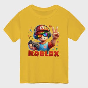 May include: Yellow short-sleeve t-shirt featuring a cartoon character with headphones, rainbow-colored glasses, and a game controller. The character is giving a peace sign. The word "ROBLOX" is printed in red and orange block letters.