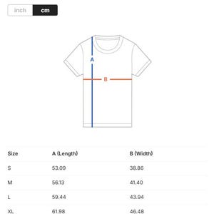May include: White t-shirt with a diagram showing length and width measurements. The diagram includes measurements in centimeters for sizes S, M, L, and XL. The image also shows the option to switch between inches and centimeters.