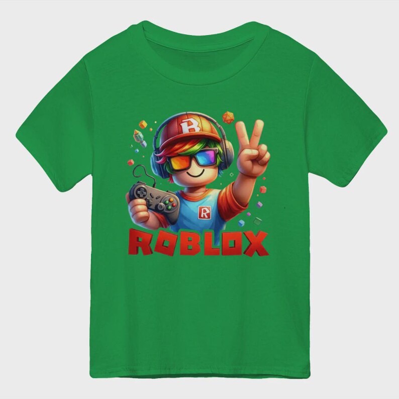 May include: Green t-shirt featuring a cartoon character with headphones, rainbow glasses, and a controller. The character is giving a peace sign. The word "ROBLOX" is printed in red block letters at the bottom of the shirt.