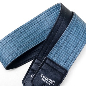 May include: A blue and black guitar strap with a houndstooth pattern and the text "Couch" and "hand made".