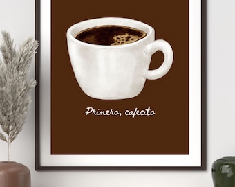 May include: A framed art print featuring a white coffee cup filled with dark coffee. The words "Primero, cafecito" are written in cursive below the cup. The background is a solid brown.